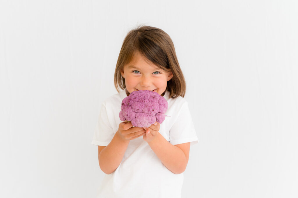 child with purple cauliflower