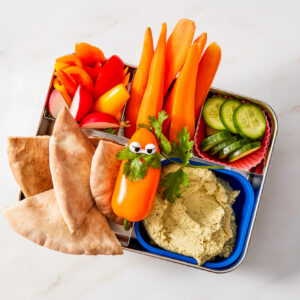 Cilantro hummus in a bento box with pita bread and vegetable dippers