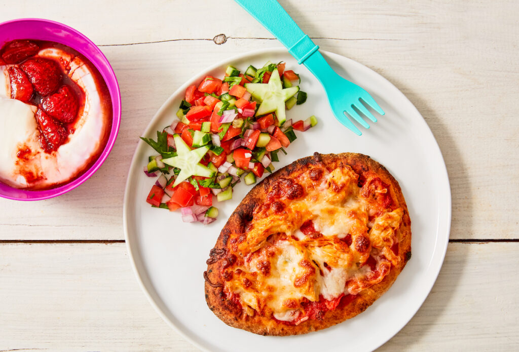 Naan pizza on plate with salad