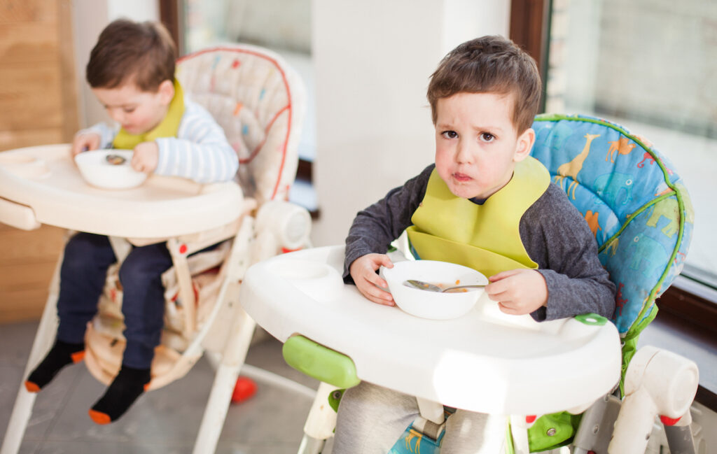 Toddler is unhappy in high chair demonstrating when to stop using high chairs