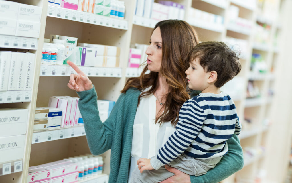 Mother and son look at probiotics supplements