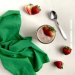 Strawberry chia pudding in jar with fresh strawberries