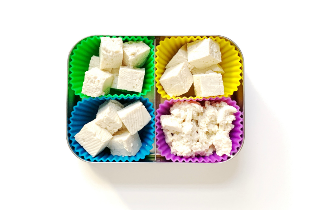 Tofu cut in different ways in colorful silicone holders