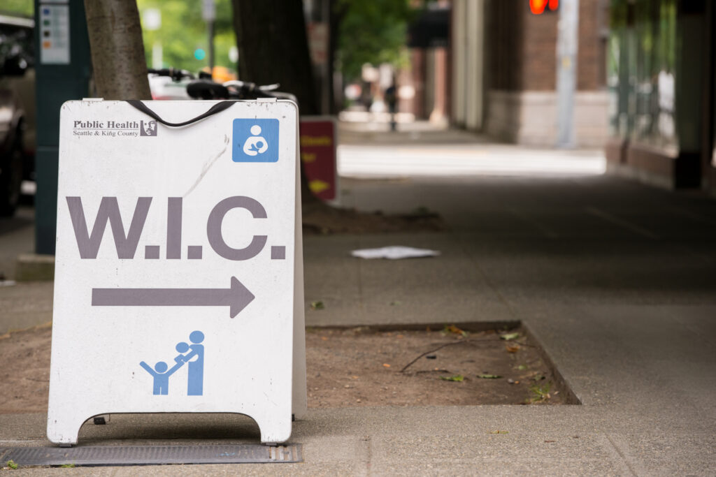 WIC nutrition program sign on a sidewalk