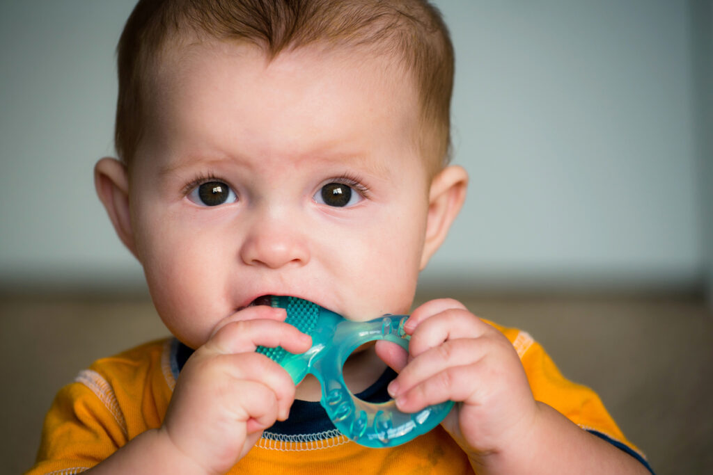 Baby chewing on a textured teether