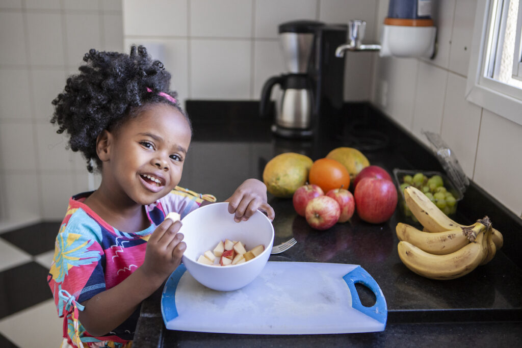 Child posing in a kitchen with 